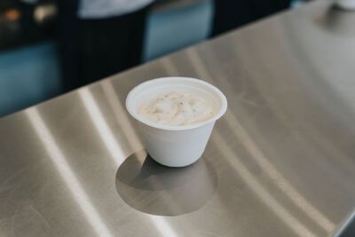 Cup of tartar sauce on the stainless steel counter
